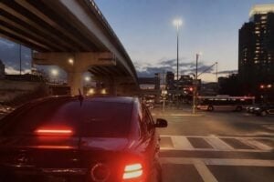 A busy Houston street at dusk with brake lights glowing