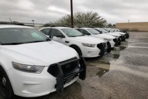 Row of police cars in a parking lot